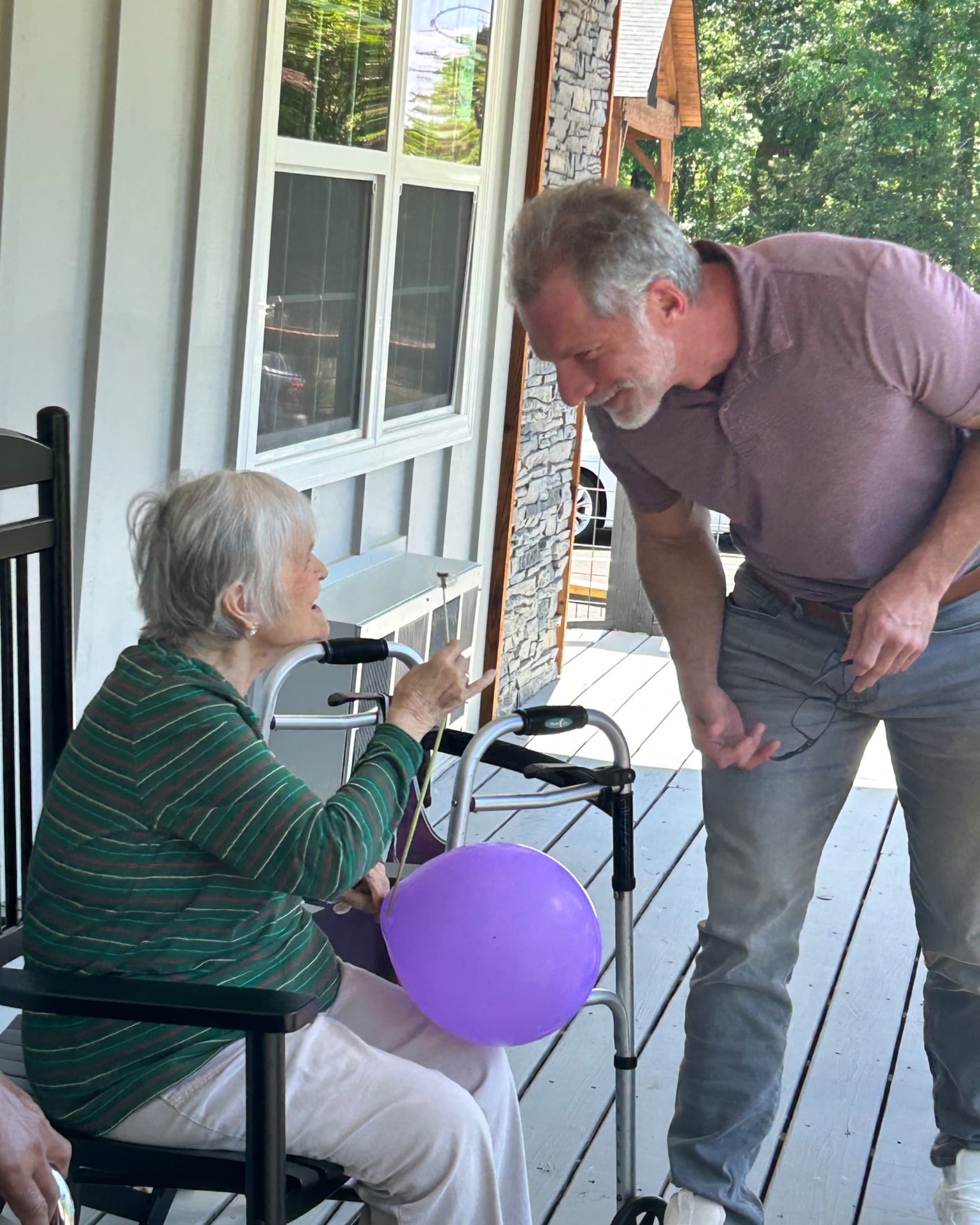 A caregiver helping a resident through the day at Joy Senior Living